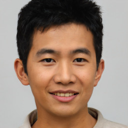 Joyful asian young-adult male with short  black hair and brown eyes