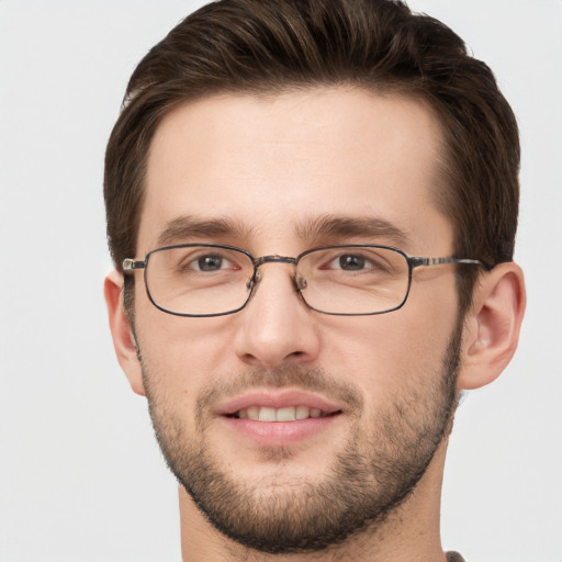 Joyful white young-adult male with short  brown hair and grey eyes