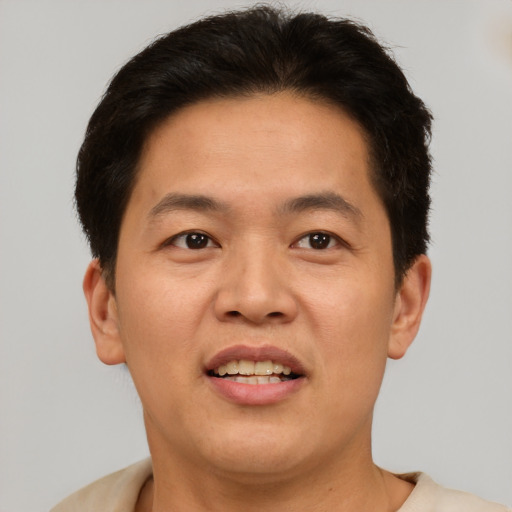 Joyful white adult male with short  brown hair and brown eyes