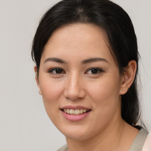 Joyful asian young-adult female with medium  brown hair and brown eyes