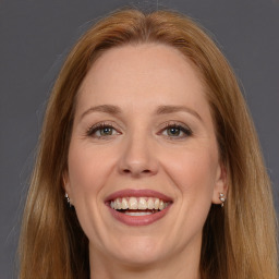 Joyful white adult female with long  brown hair and brown eyes