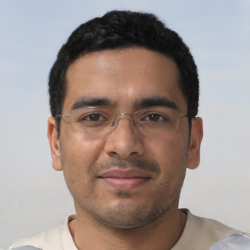 Joyful latino young-adult male with short  black hair and brown eyes