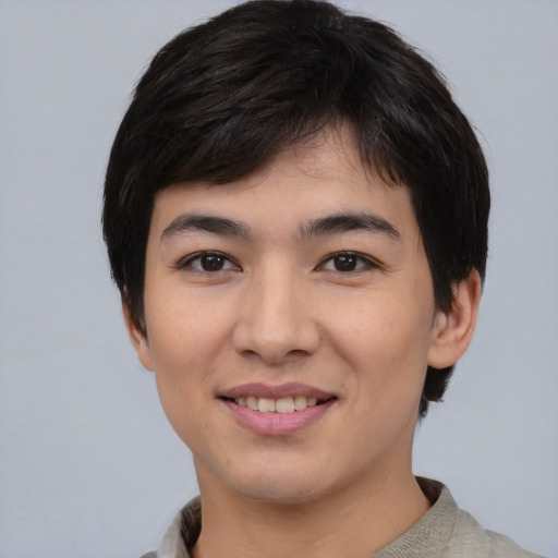 Joyful asian young-adult male with short  black hair and brown eyes