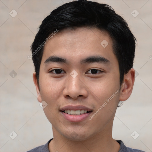 Joyful asian young-adult male with short  black hair and brown eyes