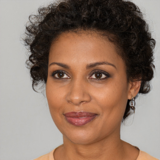 Joyful black young-adult female with medium  brown hair and brown eyes