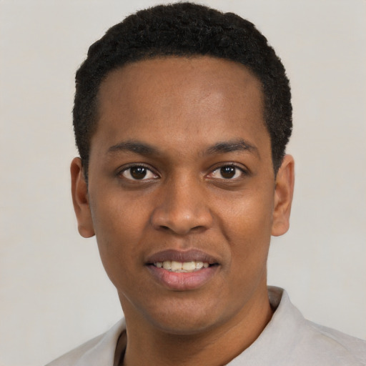 Joyful black young-adult male with short  black hair and brown eyes