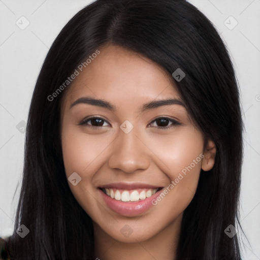 Joyful latino young-adult female with long  brown hair and brown eyes