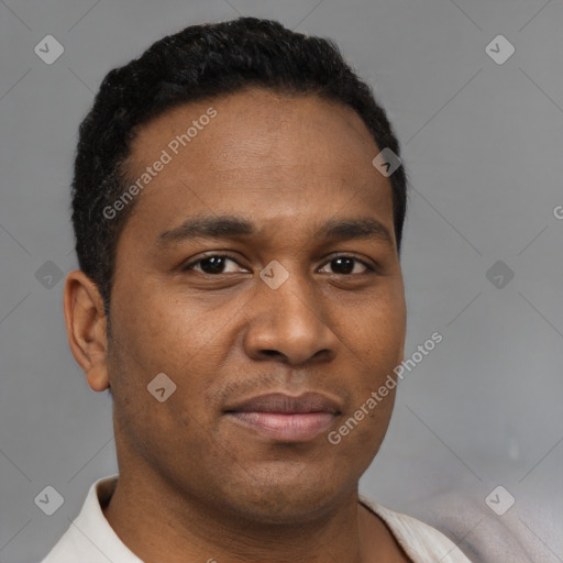 Joyful black young-adult male with short  brown hair and brown eyes