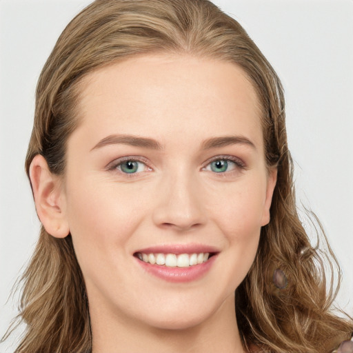 Joyful white young-adult female with long  brown hair and blue eyes