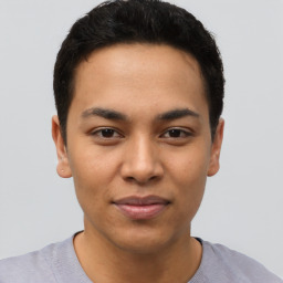 Joyful latino young-adult male with short  brown hair and brown eyes