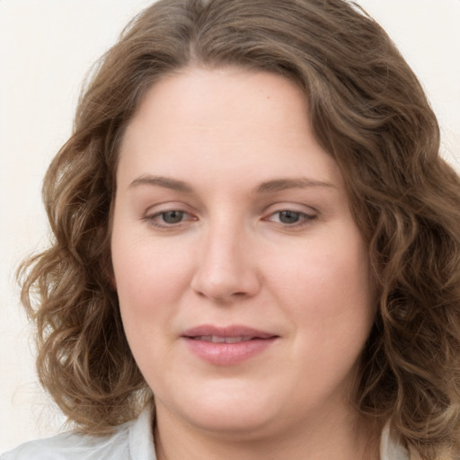 Joyful white young-adult female with medium  brown hair and green eyes