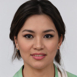 Joyful latino young-adult female with medium  brown hair and brown eyes