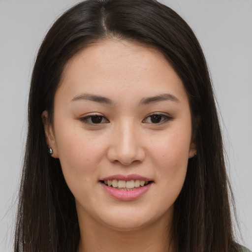 Joyful asian young-adult female with long  brown hair and brown eyes