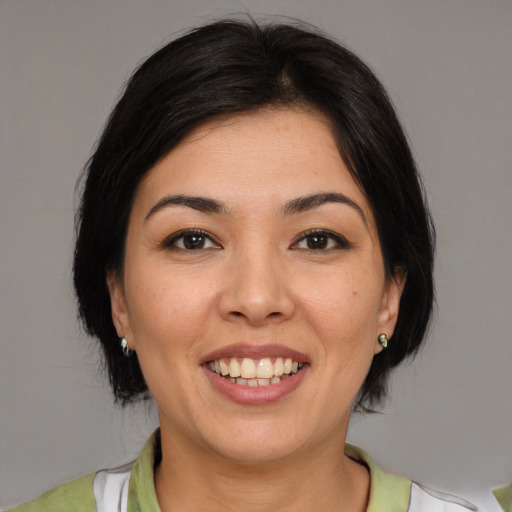Joyful white young-adult female with medium  brown hair and brown eyes