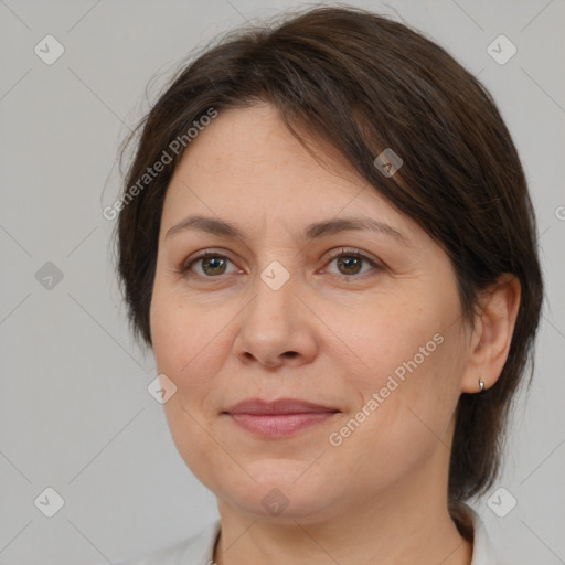 Joyful white adult female with medium  brown hair and brown eyes