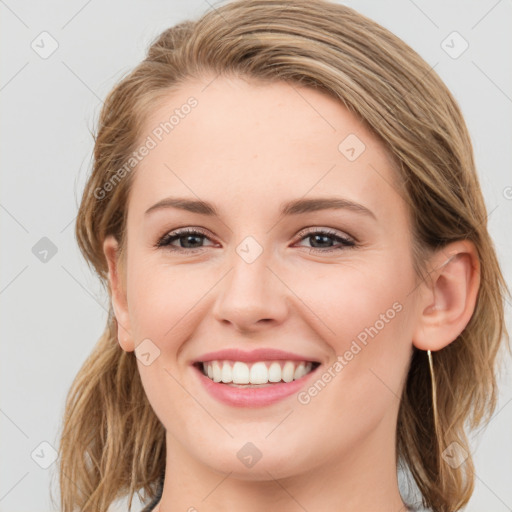 Joyful white young-adult female with long  brown hair and blue eyes