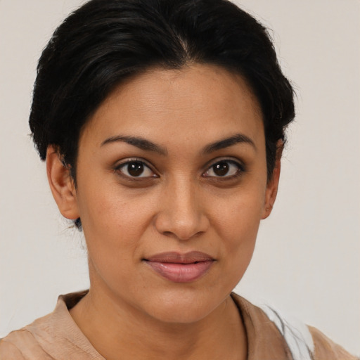 Joyful latino young-adult female with short  brown hair and brown eyes