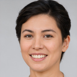 Joyful white young-adult female with medium  brown hair and brown eyes