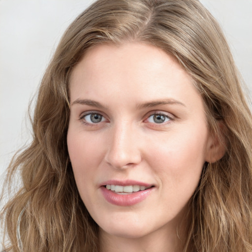 Joyful white young-adult female with long  brown hair and blue eyes