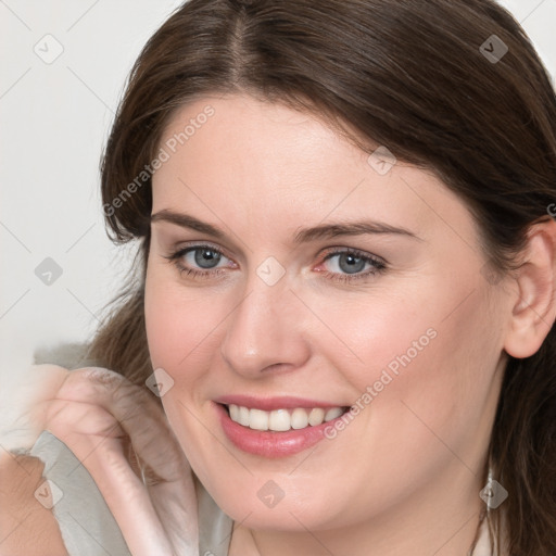 Joyful white young-adult female with medium  brown hair and blue eyes