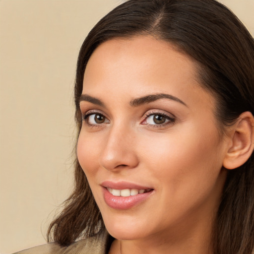 Joyful white young-adult female with long  brown hair and brown eyes