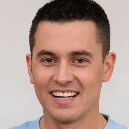 Joyful white young-adult male with short  brown hair and brown eyes