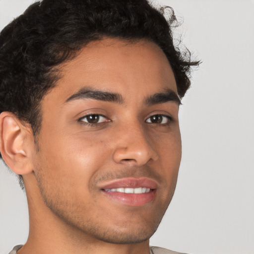 Joyful latino young-adult male with short  brown hair and brown eyes