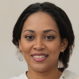 Joyful latino adult female with medium  brown hair and brown eyes