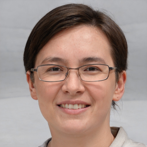 Joyful white adult female with short  brown hair and grey eyes