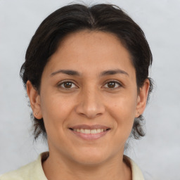 Joyful white adult female with medium  brown hair and brown eyes