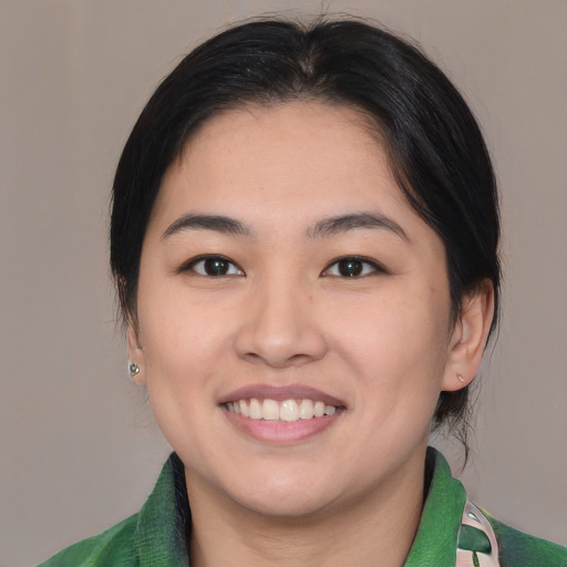 Joyful asian young-adult female with medium  brown hair and brown eyes