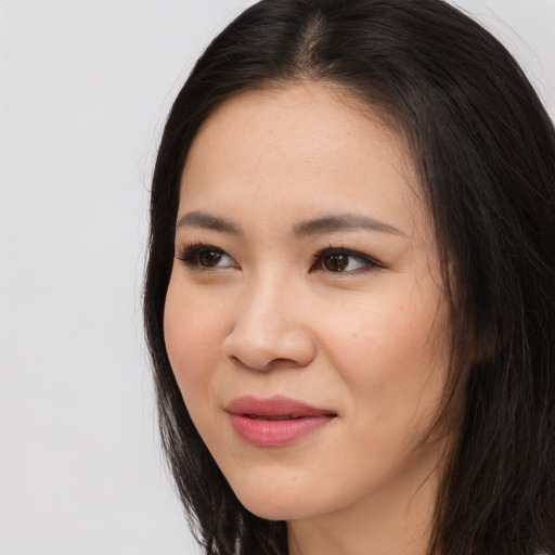 Joyful asian young-adult female with long  brown hair and brown eyes