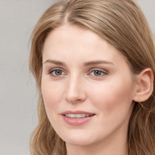 Joyful white young-adult female with long  brown hair and blue eyes