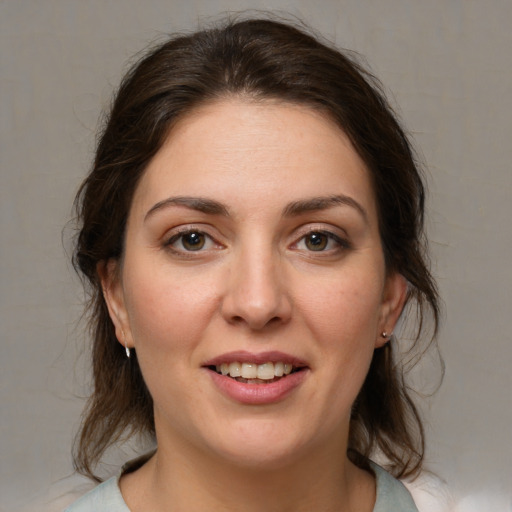 Joyful white young-adult female with medium  brown hair and brown eyes