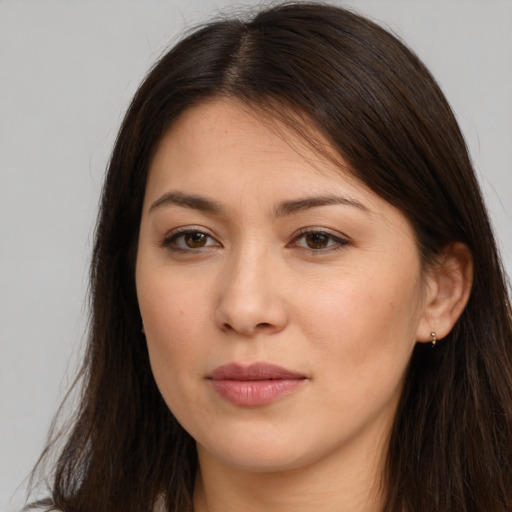 Joyful white young-adult female with long  brown hair and brown eyes