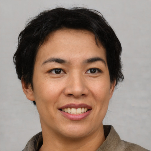 Joyful asian young-adult female with short  brown hair and brown eyes