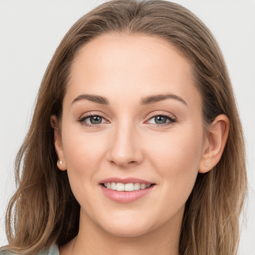 Joyful white young-adult female with long  brown hair and grey eyes