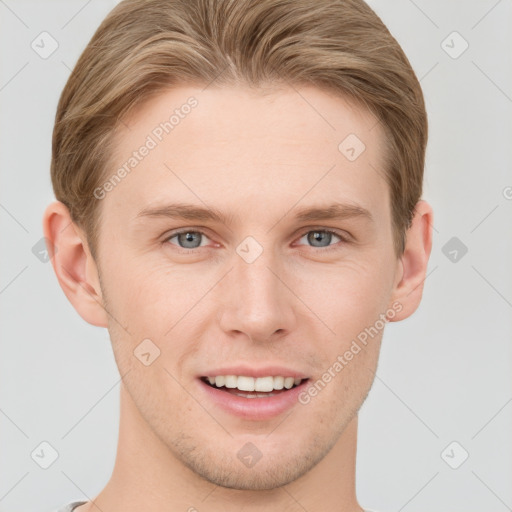 Joyful white young-adult male with short  brown hair and grey eyes