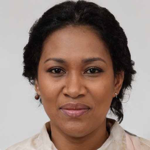 Joyful black adult female with medium  black hair and brown eyes