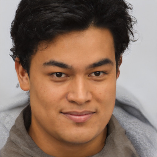 Joyful asian young-adult male with short  brown hair and brown eyes