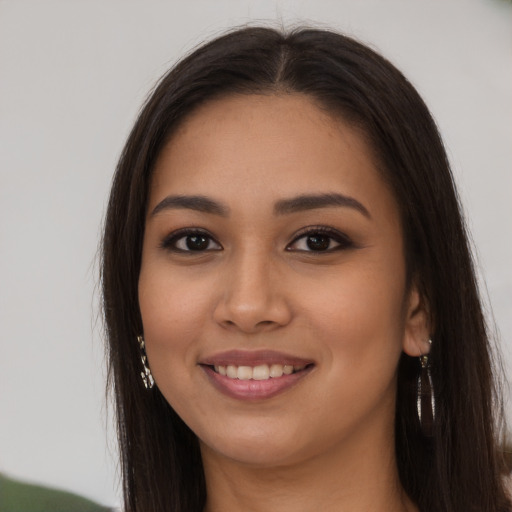 Joyful latino young-adult female with long  brown hair and brown eyes