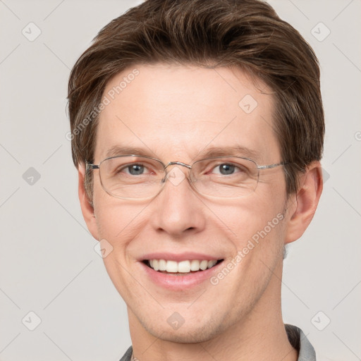 Joyful white adult male with short  brown hair and grey eyes