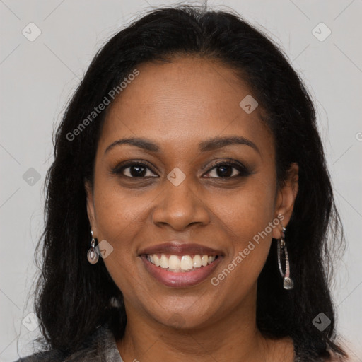 Joyful black young-adult female with long  brown hair and brown eyes