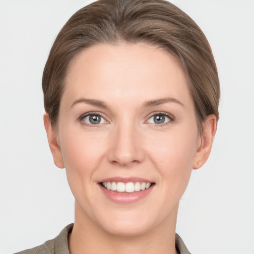 Joyful white young-adult female with short  brown hair and grey eyes