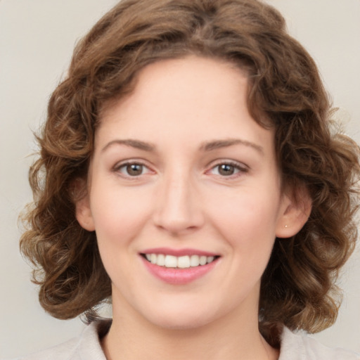 Joyful white young-adult female with medium  brown hair and green eyes