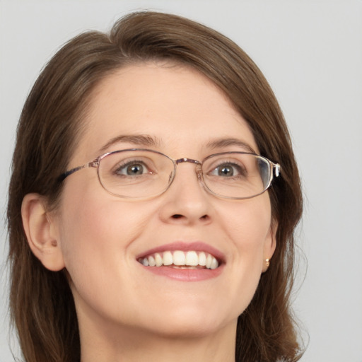 Joyful white adult female with medium  brown hair and blue eyes