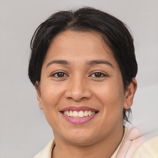 Joyful asian young-adult female with short  brown hair and brown eyes