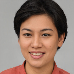 Joyful asian young-adult female with short  brown hair and brown eyes