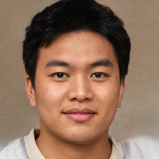Joyful asian young-adult male with short  black hair and brown eyes