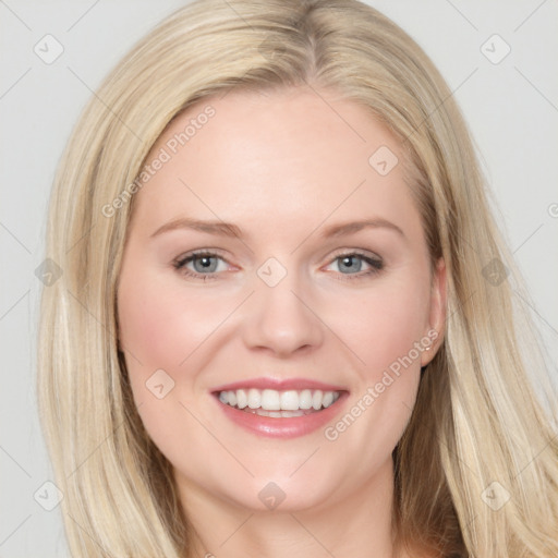 Joyful white young-adult female with long  brown hair and blue eyes